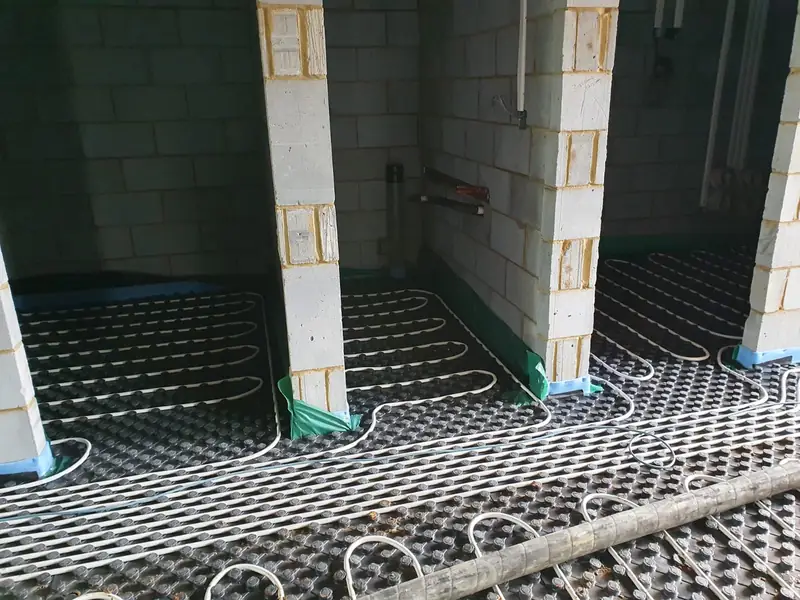 Underfloor heating loops laid in a blockwork room before the screed pour